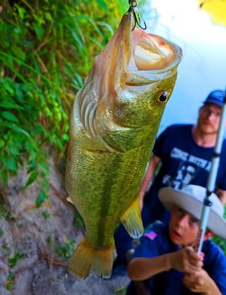 Cadet holding a largemouth bass at River Bone Ranch